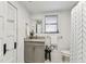 Small bathroom features new fixtures, vanity with granite, and decorative shower curtain at 904 E Hamilton Ave, Tampa, FL 33604