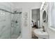 Well-lit bathroom with a glass-enclosed shower featuring marble-style tile and a sleek, modern sink at 904 E Hamilton Ave, Tampa, FL 33604