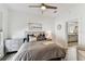 Cozy bedroom showcasing soothing neutral colors, a ceiling fan, and an ensuite at 904 E Hamilton Ave, Tampa, FL 33604