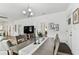 Bright dining room flowing into the living room, featuring a stylish chandelier and table setting at 904 E Hamilton Ave, Tampa, FL 33604