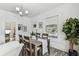 Open-concept dining area with abundant natural light, stylish furniture and access to more rooms at 904 E Hamilton Ave, Tampa, FL 33604