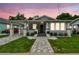 Charming home featuring a quaint front porch, freshly painted exterior, and beautifully manicured landscaping at 904 E Hamilton Ave, Tampa, FL 33604