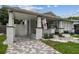 Charming home featuring a quaint front porch, freshly painted exterior, and beautifully manicured landscaping at 904 E Hamilton Ave, Tampa, FL 33604