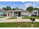 Charming home featuring a quaint front porch, freshly painted exterior, and beautifully manicured landscaping at 904 E Hamilton Ave, Tampa, FL 33604