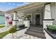 Charming home featuring a quaint front porch, freshly painted exterior, and beautifully manicured landscaping at 904 E Hamilton Ave, Tampa, FL 33604