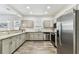 Modern kitchen with gray cabinets and stainless steel appliances at 904 E Hamilton Ave, Tampa, FL 33604