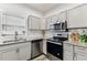 Well-lit kitchen with stainless steel appliances and granite countertops at 904 E Hamilton Ave, Tampa, FL 33604