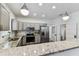 Bright kitchen features stainless steel appliances, grey cabinets, and granite countertops at 904 E Hamilton Ave, Tampa, FL 33604