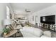 Bright living room with gray hardwood floors and comfortable seating at 904 E Hamilton Ave, Tampa, FL 33604