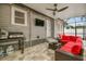 Outdoor kitchen featuring a grill, television, fan, and comfortable sofa seating at 904 E Hamilton Ave, Tampa, FL 33604