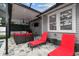 Outdoor kitchen area with grill, television, fan, lounge chair, and an outdoor sofa at 904 E Hamilton Ave, Tampa, FL 33604