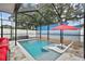Screened-in pool and patio area with hot tub, beach mural and outdoor seating at 904 E Hamilton Ave, Tampa, FL 33604