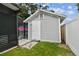 An exterior view of the storage shed, including a partial view of the pool and patio area at 904 E Hamilton Ave, Tampa, FL 33604