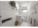 Charming bathroom featuring beadboard paneling, decorative accents, and a window at 917 W Idlewild Ave, Tampa, FL 33604