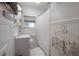 Cozy bathroom with white beadboard, decorative accents, and shower curtain at 917 W Idlewild Ave, Tampa, FL 33604