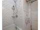 Shower and tub area with white subway tile and vintage-style fixtures at 917 W Idlewild Ave, Tampa, FL 33604