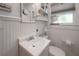 Well-lit bathroom with vanity, mirror, toilet, and window with natural light at 917 W Idlewild Ave, Tampa, FL 33604