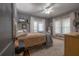 Comfortable bedroom with many windows, ceiling fan, neutral rug, and hardwood floors at 917 W Idlewild Ave, Tampa, FL 33604