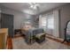 Bedroom with ceiling fan, neutral colored rug, and hardwood floors at 917 W Idlewild Ave, Tampa, FL 33604