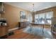 Traditional dining room with hardwood floors, modern chandelier, neutral walls, and blue accent rug at 917 W Idlewild Ave, Tampa, FL 33604