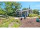 Charming exterior view of a well-maintained home with a screened porch and lush landscaping at 917 W Idlewild Ave, Tampa, FL 33604