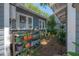 Exterior shot displaying side yard with water heater and colorful plants on shelves at 917 W Idlewild Ave, Tampa, FL 33604