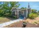 Charming bungalow with a screened front porch, brick accents, and a well-maintained yard at 917 W Idlewild Ave, Tampa, FL 33604
