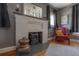 Living room with a decorative fireplace, vintage decor, and a cozy reading chair at 917 W Idlewild Ave, Tampa, FL 33604