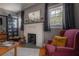 Living room with a charming brick fireplace, a wingback chair, and a full bookshelf at 917 W Idlewild Ave, Tampa, FL 33604