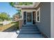 Charming front entrance with brick pillars, decorative storm door and a quaint picket fence at 917 W Idlewild Ave, Tampa, FL 33604