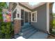 Charming front entrance with brick pillars, colorful flower flag and a decorative storm door at 917 W Idlewild Ave, Tampa, FL 33604