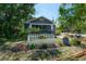 Home showcasing a front yard with a white picket fence and mature trees at 917 W Idlewild Ave, Tampa, FL 33604