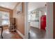 View of the kitchen from the hallway with updated cabinets, white subway tile, dark counters and red retro refrigerator at 917 W Idlewild Ave, Tampa, FL 33604