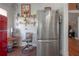 Bright kitchen featuring stainless steel refrigerator, decorative shelving, and adjacent kitchen nook at 917 W Idlewild Ave, Tampa, FL 33604
