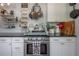 Updated kitchen boasts stainless steel oven, white cabinetry, black countertop, and decorative elements at 917 W Idlewild Ave, Tampa, FL 33604
