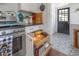 Kitchen with stainless steel stove, built in cabinets, and decorative tiled floor at 917 W Idlewild Ave, Tampa, FL 33604