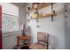 Quaint kitchen nook with wooden chair, small table, and decorative open shelving, next to a window at 917 W Idlewild Ave, Tampa, FL 33604