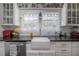 Bright kitchen features a farmhouse sink, granite countertops, and white subway tile backsplash at 917 W Idlewild Ave, Tampa, FL 33604