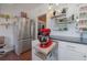 Cozy kitchen with stainless steel refrigerator, red kitchen aid mixer and floating shelving at 917 W Idlewild Ave, Tampa, FL 33604