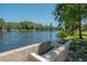 Peaceful lake view with benches, lush greenery, and tranquil water at 917 W Idlewild Ave, Tampa, FL 33604