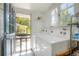 Laundry room features patterned tiled floors, large windows, and washer and dryer at 917 W Idlewild Ave, Tampa, FL 33604