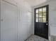 Laundry room with storage, tiled floors and direct access to backyard at 917 W Idlewild Ave, Tampa, FL 33604