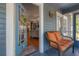 Inviting front porch with cozy seating, showcasing a glimpse into the living room at 917 W Idlewild Ave, Tampa, FL 33604