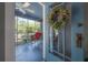 Cozy screened porch featuring a red rocking chair and a view of the outdoors at 917 W Idlewild Ave, Tampa, FL 33604
