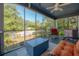 Inviting screened porch with comfortable seating and views of the landscaped front yard and neighborhood at 917 W Idlewild Ave, Tampa, FL 33604