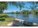 Beautiful waterfront view with concrete bench, offering serene spot to enjoy the scenery at 917 W Idlewild Ave, Tampa, FL 33604