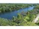 Aerial view of a tranquil lake with a boat and lush green trees at 917 W Idlewild Ave, Tampa, FL 33604