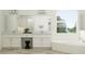 Bright bathroom with a dual sink vanity, soaking tub, and white tile at 9542 Minnow Ray Dr, Land O Lakes, FL 34638