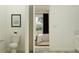 Half bathroom showing modern toilet and view into the bedroom with natural light at 9542 Minnow Ray Dr, Land O Lakes, FL 34638