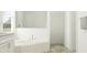 Modern bathroom featuring a soaking tub with white subway tile and walk-in shower at 9542 Minnow Ray Dr, Land O Lakes, FL 34638